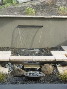 outdoor fireplace with littel waterfall