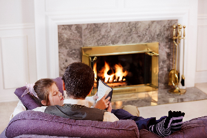 Father and Daughter in Front of Fireplace